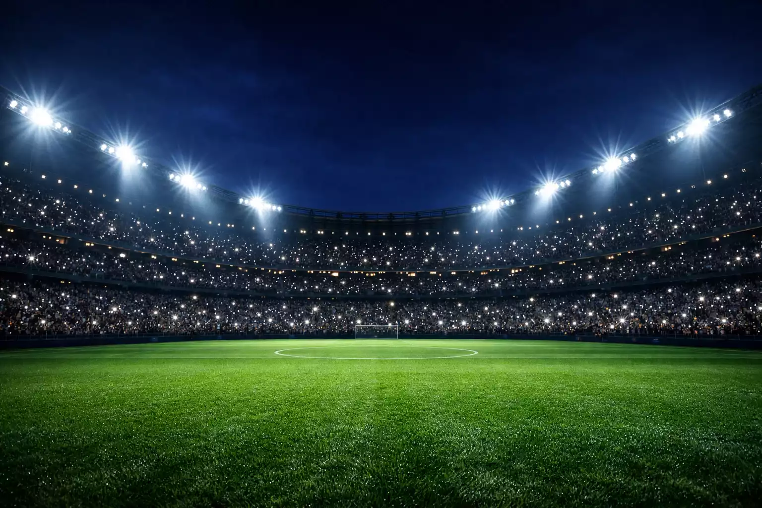 Estadio de fútbol europeo iluminado para una noche de Champions